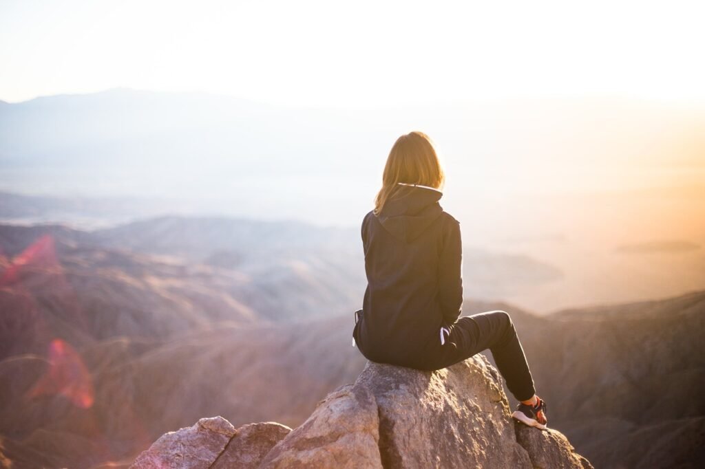 people, woman, nature, travel, adventure, trek, mountain, rock, sunset, cliff, black, hoodie, jacket, alone, thinking, freedom