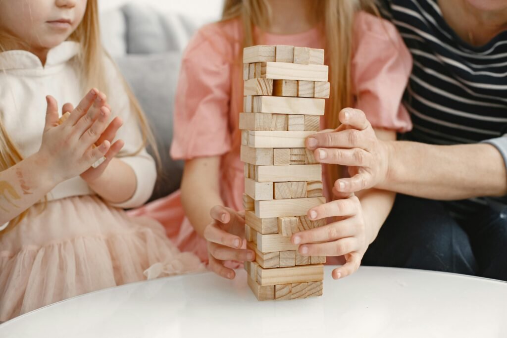 Children and parents playing Jenga together, showcasing family bonding and fun.